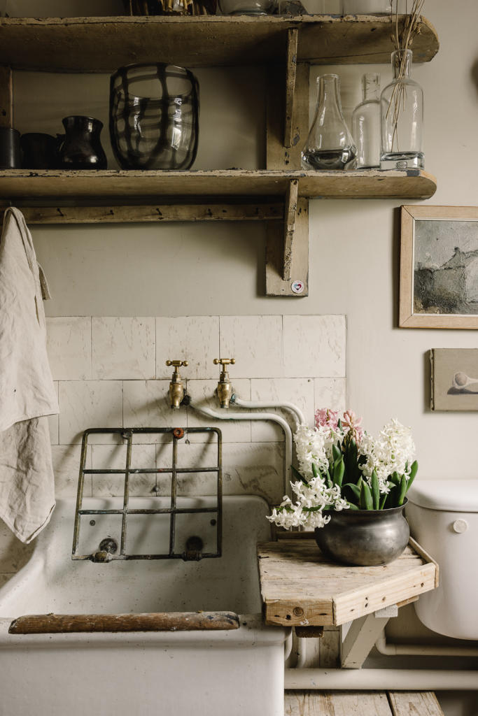 Vintage sink with brass taps and hyacinths at Cotherstone House